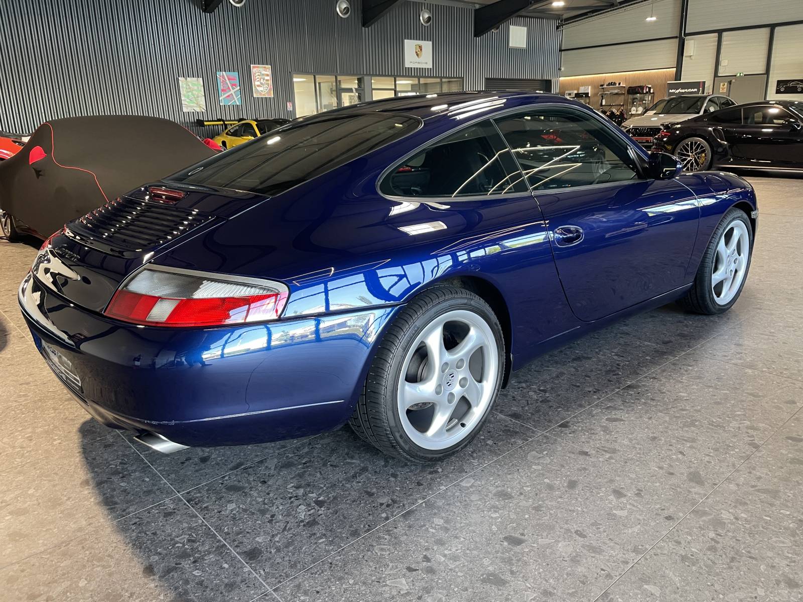 Vue de trois-quart arrière : Arrière large et sorties chromées Porsche 911 Carrera 996.